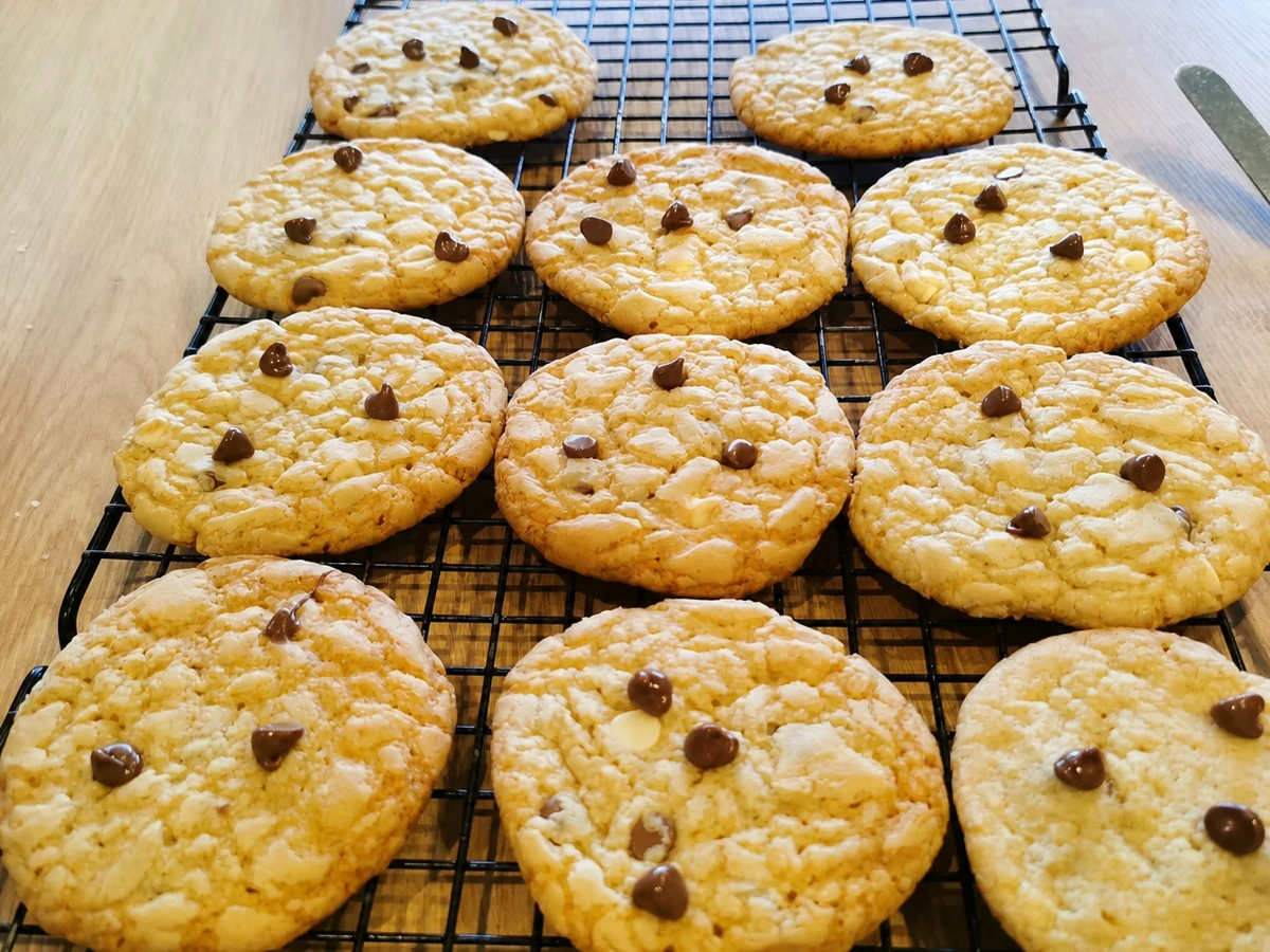 Finished chocolate chip cookies cooling on a wire rack
